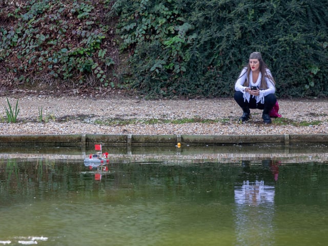 Pirate Poppy Stokes near one of the make shift boats made out of coke bottles