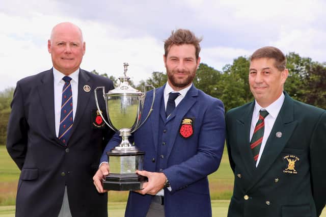 Hayling's Toby Burden holding the Sloane Stanley Challenge Cup with (left) Alan Drayton (Hampshire Golf president) and Army GC club captain Kevin White after winning the 2019 Hampshire & Isle of Wight Championship at the Army GC. Pic: Andrew Griffin.
