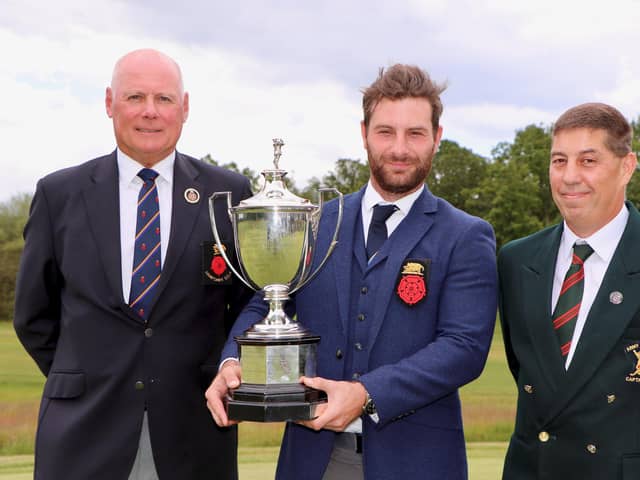 Hayling's Toby Burden holding the Sloane Stanley Challenge Cup with (left) Alan Drayton (Hampshire Golf president) and Army GC club captain Kevin White after winning the 2019 Hampshire & Isle of Wight Championship at the Army GC. Pic: Andrew Griffin.