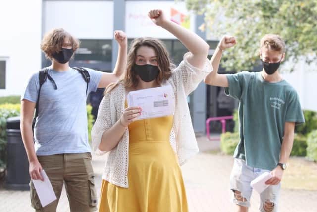 Portsmouth College students Daniel Bayliss, Chloe Cotterill and Daniel Hill collect results and safely socially distance
