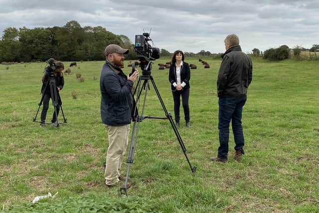 Christine Lord from Southsea with regular presenter Tom Heap and Countryfile drone and camera crew filming at a farm in Hampshire