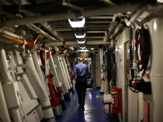 A female sailor seen walking through a corridor on HMS Illustrious back in May 10, 2013. Photo by Dan Kitwood/Getty Images