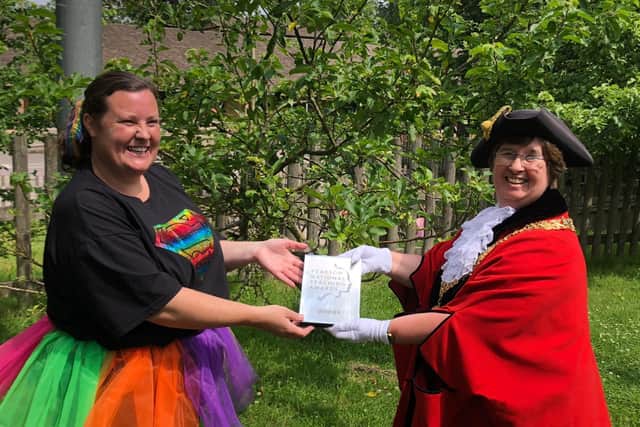 Becky Sutton receiving her award from the Mayor of Winchester, Councillor Vivian Achwal.