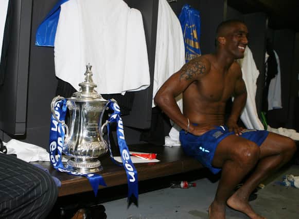 Sylvain Distin and the FA Cup sit in Pompey's dressing room following their 2008 FA Cup win over Cardiff. Picture: Joe Pepler