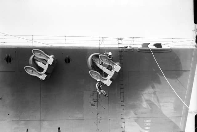 Sailors painting HMS Nelson's anchor, April 1929. Picture: Getty