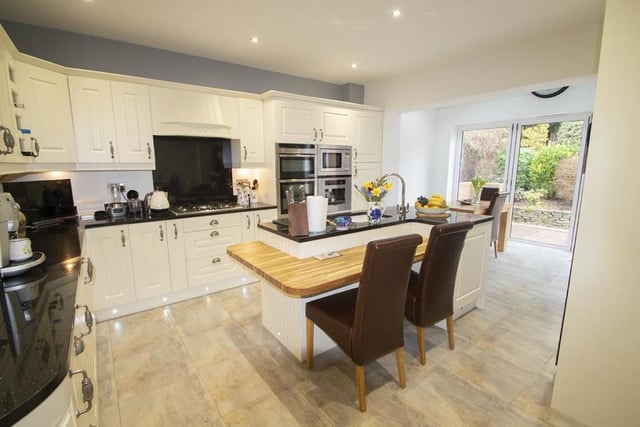 The kitchen offers built in appliances, including a coffee machine.