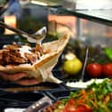 An employee prepares a doner. File photo for illustrative purposes. (Photo by INA FASSBENDER/AFP via Getty Images)