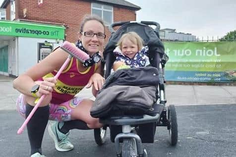 Kerry Riches running with child and broom