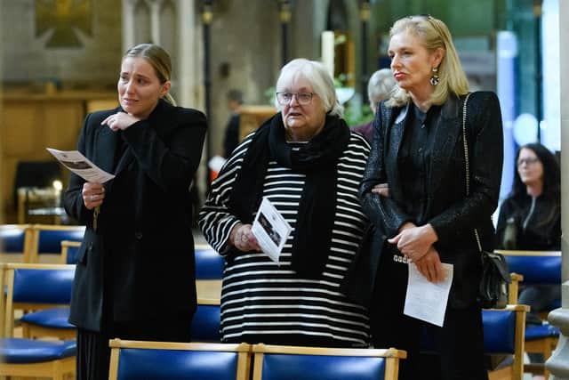 Pictured is: Charlie Omara, Jill Haycock, Sara Gingras react at the end of the national anthem during the service at St Mary's Church. 

Picture: Keith Woodland (170921-46)