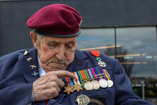 Arthur descriibes his medals. Pictured: The 39-45 star, France and Germany star, Defence Medal, 1939-45 War Medal and General Service Medal with Palestine clasp. Also shown (above, with red ribbon) is the Legion d'Honneur. Picture: Mike Cooter (140422)