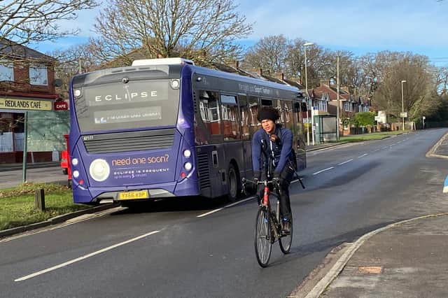 A cyclist pictured passing a bus in Redlands Lane, Fareham, on Saturday - a day after a hit and run left a 24-year-old man injured. Photo: Tom Cotterill