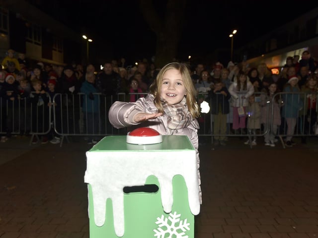 Esme Mullins (7) from Portchester helps turn the Christmas lights on.  Picture: Sarah Standing (291124-6798)