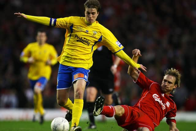 Jamie Collins is challenged by Sami Hyypia during Hawks' FA Cup fourth round tie at Anfield in 2008. Photo by Paul Gilham/Getty Images.