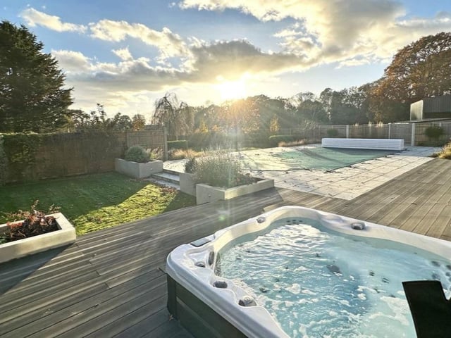 The listing says: "Beautifully presented detached family home with superb kitchen/dining/family room, four bedrooms, three en suite shower rooms and family bathroom, detached two bedroom self contained annexe, set in a quiet country lane with south facing gardens, heated outdoor pool and views over neighbouring fields."