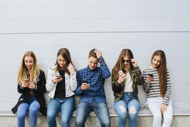 Teenagers on mobile phones