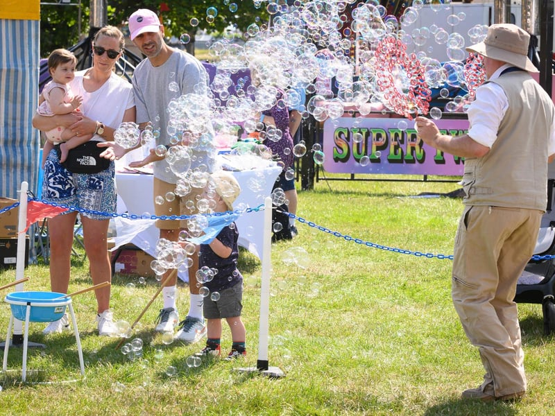 A family enjoy enjoy the bubbles at the Party in the ParkPicture: Keith Woodland (270721-31)