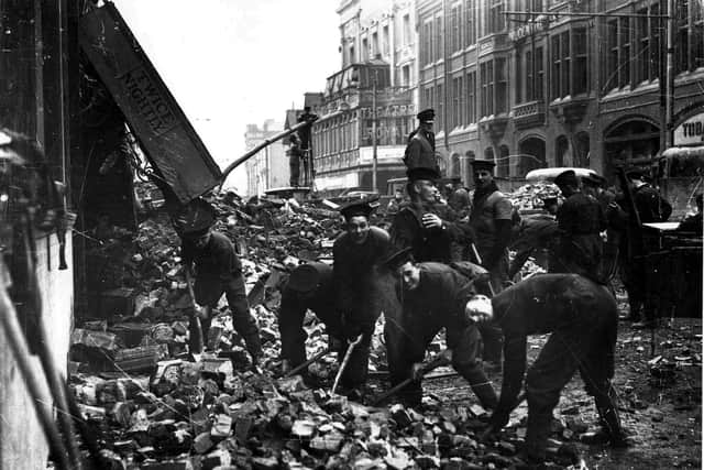 Sailors clearing debris from the remains of the Hippodrome, Commercial Road