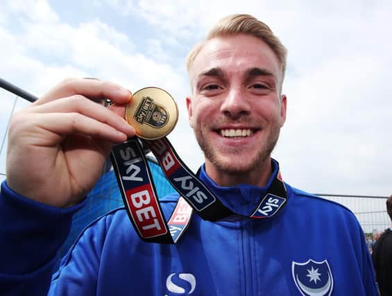 Jack Whatmough displays his League Two title-winning medal at the Southsea Common celebrations in May 2017. Now all that squad have left Pompey. Picture: Joe Pepler