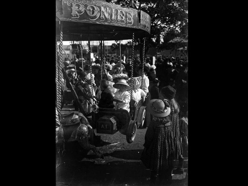 circa 1900: Children riding on the carousel at Southsea fairground. (Photo by Hulton Archive/Getty Images)