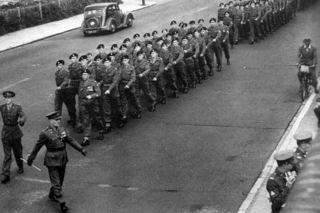 Soldiers entering Hilsea Barracks. Can anyone put names to faces and/or tell me what the occasion was? Picture: Mick Cooper collection.