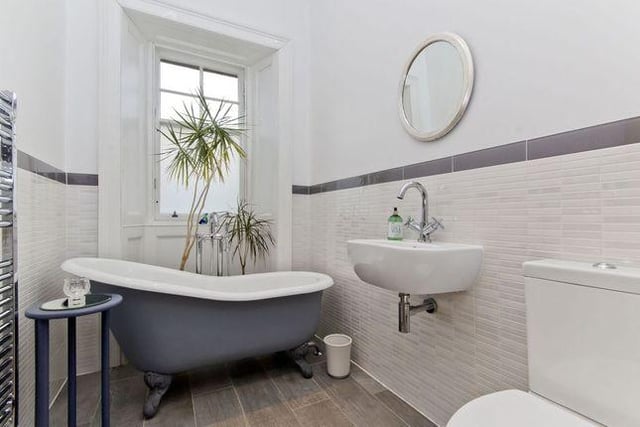 The property boasts a luxurious three-piece bathroom with a roll-top bath and electric underfloor heating