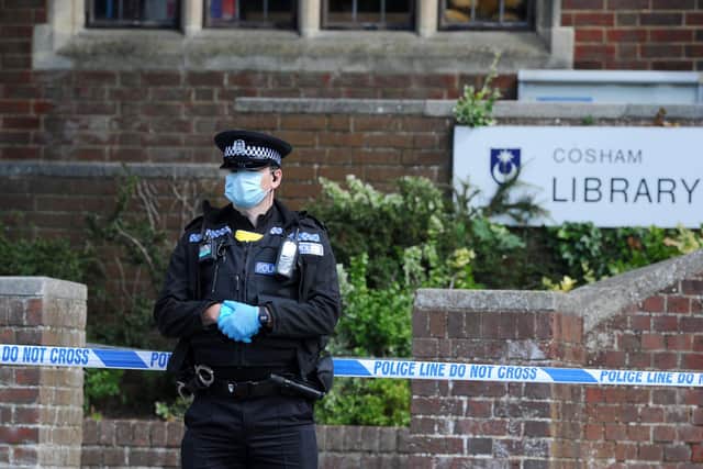 Detectives have launched an investigation after a man's body was found outside Cosham Library on Friday morning, July, 3.

Pictured is: Officers in PPE guarding the scene on Friday morning.

Picture: Sarah Standing (030720-5284)