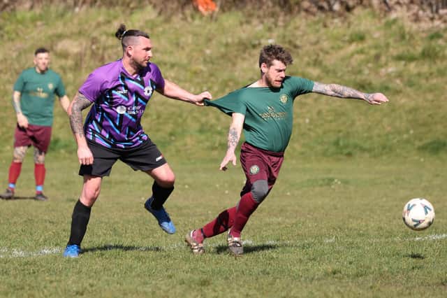 A Cross Keys Athletic  player has his shirt tugged during his side's 8-0 win over Al's Bar. Picture: Kevin Shipp