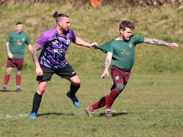 A Cross Keys Athletic  player has his shirt tugged during his side's 8-0 win over Al's Bar. Picture: Kevin Shipp