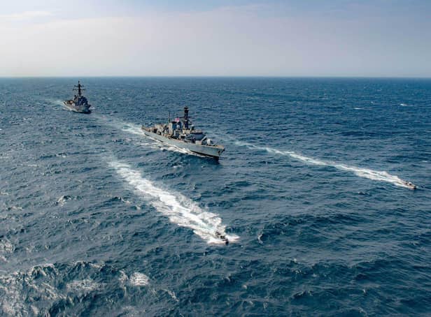HMS Montrose leads USS Winston S Churchill in the Gulf during a mission to protect critical trade routes