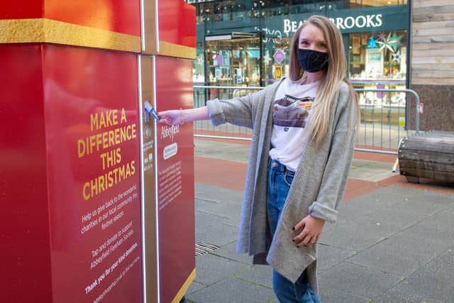 Whiteley shopping centre has put out a Giving Box to raise funds for three local charities. Natasha Stride donating at Whiteley Shopping centre