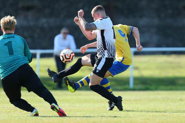 Conor Mansfield (yellow) deftly chips the keeper for his first goal against Whiteley Wanderers. Picture: Chris Moorhouse
