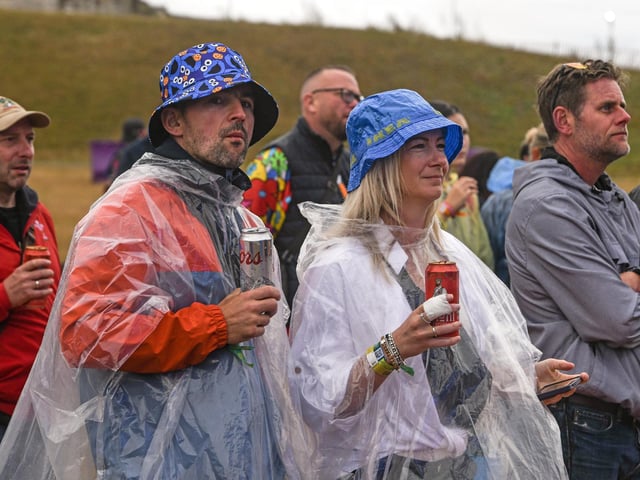 People brave the wet weather at Victorious Festival on Southsea Common in Portsmouth today during the three day event the bank holiday weekendPicture Credit: Solent News Agency