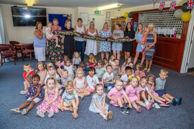St Nicholas Preschool is celebrating 60 years of providing childcare for the community of Portsmouth this yearon Wednesday 20th July 2022Pictured: Carers and the pupils celebrating at St Nicholas Preschool, North End, PortsmouthPicture: Habibur Rahman