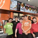 Pictured is: (front in orange) Darren Godfrey, Chopstix Noodle Bar Portsmouth franchisee, with some of the team. Picture: Sarah Standing (170924-1554)