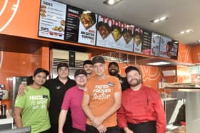 Pictured is: (front in orange) Darren Godfrey, Chopstix Noodle Bar Portsmouth franchisee, with some of the team. Picture: Sarah Standing (170924-1554)