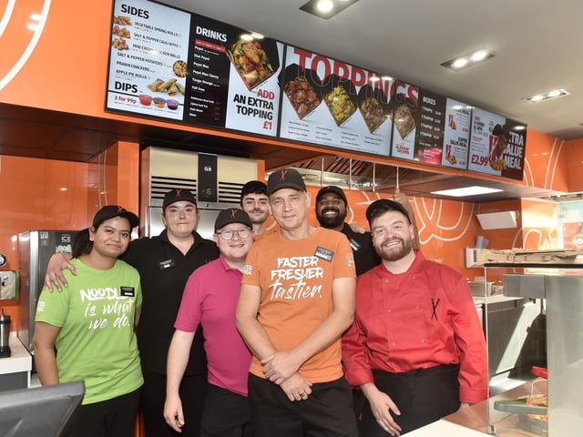 Pictured is: (front in orange) Darren Godfrey, Chopstix Noodle Bar Portsmouth franchisee, with some of the team. Picture: Sarah Standing (170924-1554)