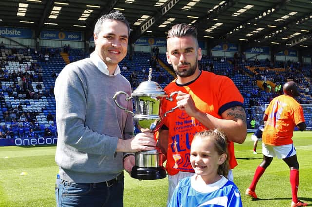 Steve Wilson hands over The News/Sport's Mail Player of the Season trophy to Ricky Holmes and his daughter Brooke in May 2014. Picture: Joe Pepler