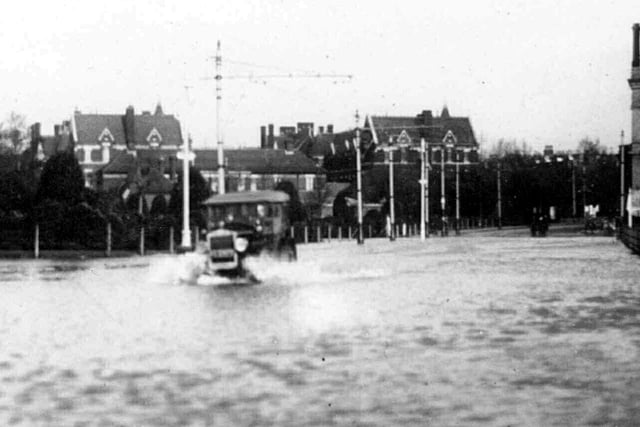 Flooding Clarence Pier Road some time between 1920-1930.Mrs Rita Wall of Southsea sent this image in. Flooding at the northern end of Pier Road at its junction with Gordon Road.In the background can be seen Victoria Barracks and to the right would be the Pier Hotel.
