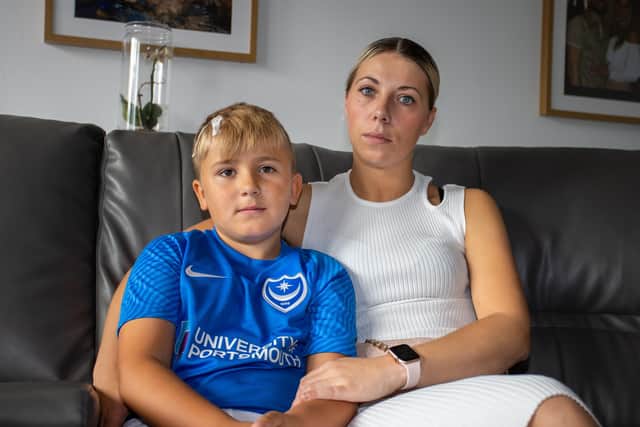 Reggie Mears, eight, with mum Ocean Parrack, recovering at home after suffering a fractured skull from a falling brick.
Picture: Alex Shute