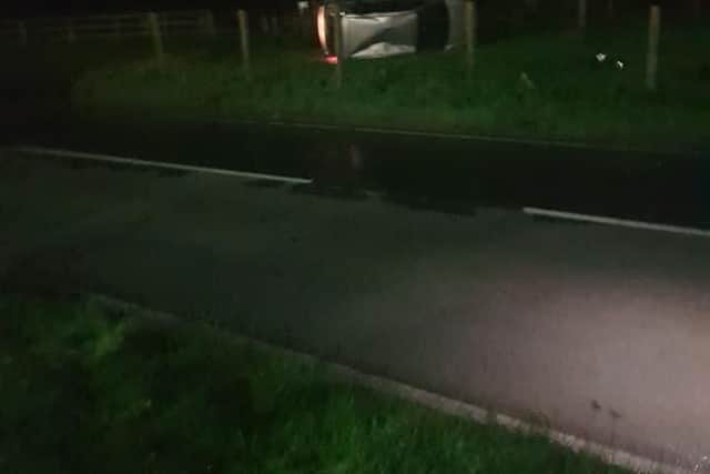 The Ford Fiesta car on its side after coming off the road.