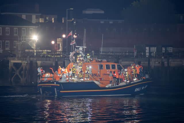 Over 100 illegal migrants aboard two RNLI lifeboats entered Portsmouth Harbour on Sunday evening just after 10pm, heading for Fort Blockhouse in Gosport, Hampshire where teams from the Home Office were there to welcome the migrants. They were then heading to board one of a number of buses waiting for them. They are pictured passing Fort Blockhouse. Pictureexclusive.com