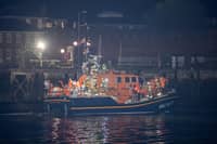 Over 100 illegal migrants aboard two RNLI lifeboats entered Portsmouth Harbour on Sunday evening just after 10pm, heading for Fort Blockhouse in Gosport, Hampshire where teams from the Home Office were there to welcome the migrants. They were then heading to board one of a number of buses waiting for them. They are pictured passing Fort Blockhouse.   Pictureexclusive.com
