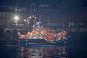 Over 100 illegal migrants aboard two RNLI lifeboats entered Portsmouth Harbour on Sunday evening just after 10pm, heading for Fort Blockhouse in Gosport, Hampshire where teams from the Home Office were there to welcome the migrants. They were then heading to board one of a number of buses waiting for them. They are pictured passing Fort Blockhouse.   Pictureexclusive.com