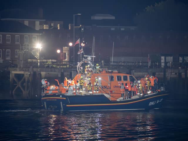 Over 100 illegal migrants aboard two RNLI lifeboats entered Portsmouth Harbour on Sunday evening just after 10pm, heading for Fort Blockhouse in Gosport, Hampshire where teams from the Home Office were there to welcome the migrants. They were then heading to board one of a number of buses waiting for them. They are pictured passing Fort Blockhouse.   Pictureexclusive.com