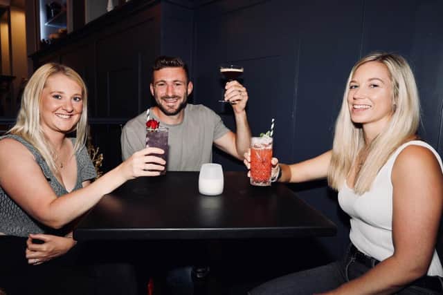 From l to r - Katie and Liam Perkins, and Alice Hosker, drinking in the Monarch. Picture: Chris Moorhouse