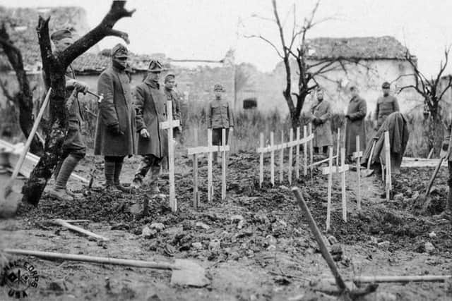 American soldiers burying their dead in temporary graves during autumn 1918.
