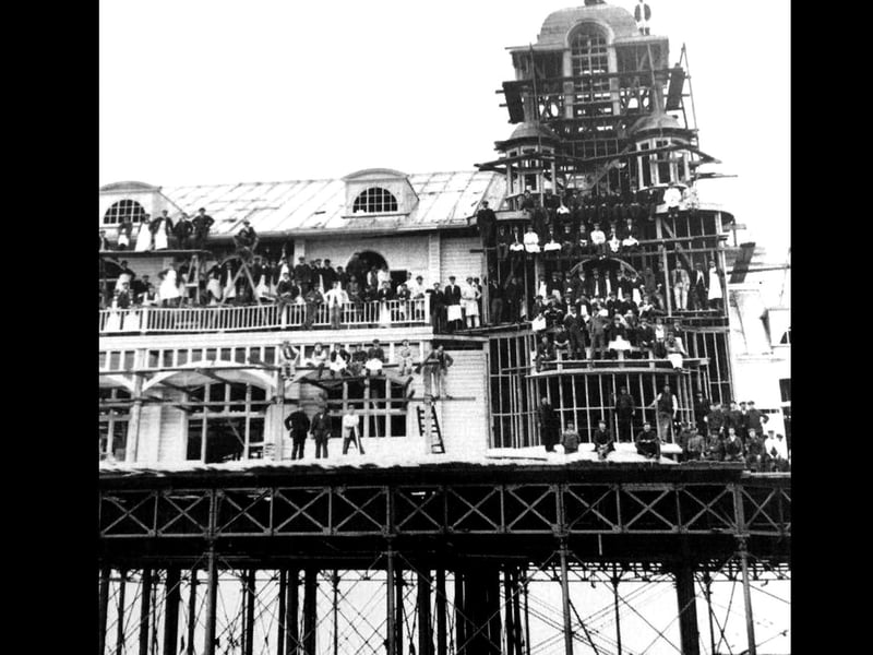 Men all over South Parade Pier 1908. Not much health and safety going on!