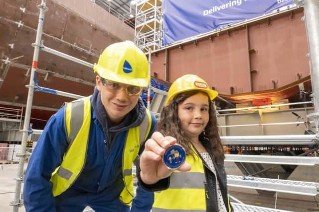 Apprentice Robbie Dick with the HMS Active coin designer.