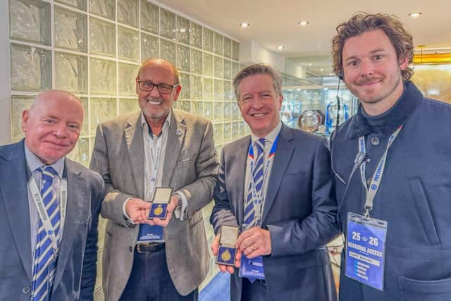Pompey chief executive Andy Cullen, third right, pictured with Martin Price, Matt Barker and Mick Comben with Peter Harris’ title-winning medals for the club’s trophy cabinet.