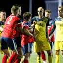 Harry Birmingham (middle of the three Moneyfields players in yellow) is available again after suspension for this weekend's Wessex League trip to Pagham. Picture by Dave Bodymore.